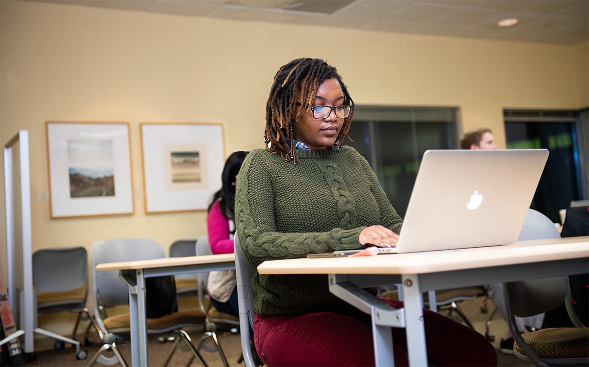 Graduate student studying at computer